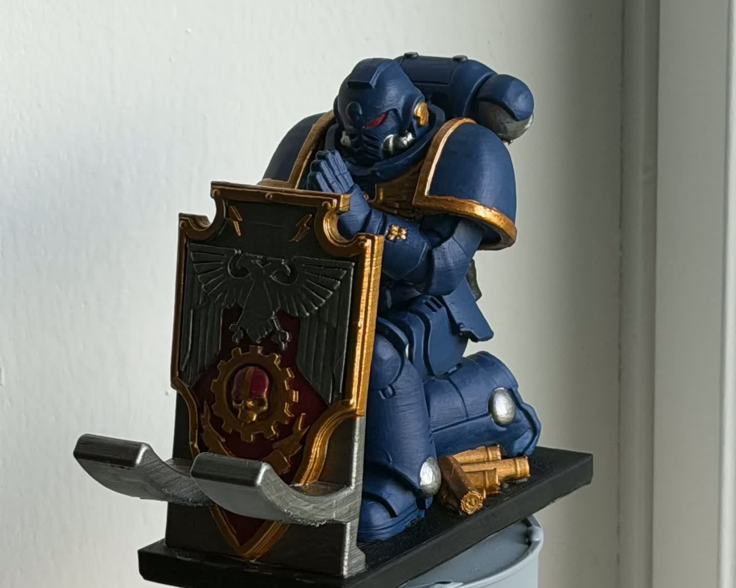 A hand-painted kneeling knight figurine with a decorated shield, made as a custom commission